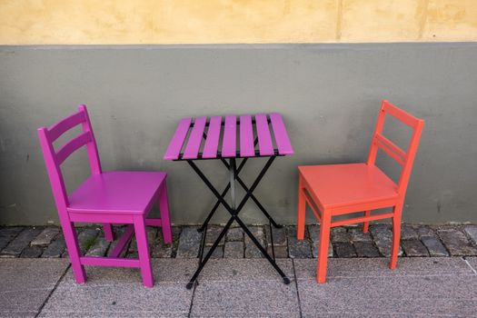 purple and orange bench in the street