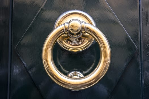  circle iron door-handle on black door