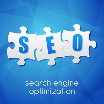 SEO in puzzle pieces, search engine optimization text over blue background, flat design, business technology concept words