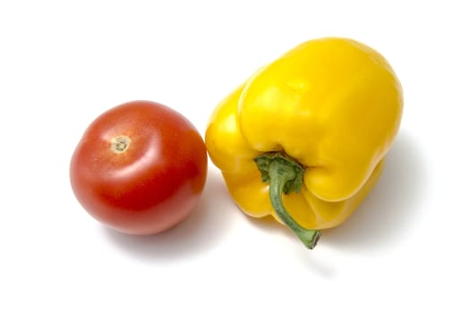 Red tamato and yellow pepper closeup on white background