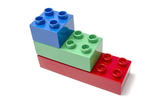 Colorful building blocks closeup on white background 