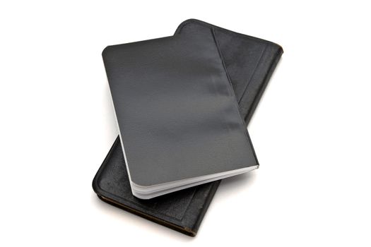 Black notebooks closeup on white background