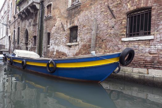Old gondola boat  in a quiet small Canal ,Venice, Italy