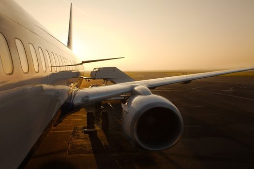 Airplane at an airport at sunrise