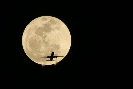 Commercial Jet Airplane Passing in front of a Full Moon- Real not Digitally Altered