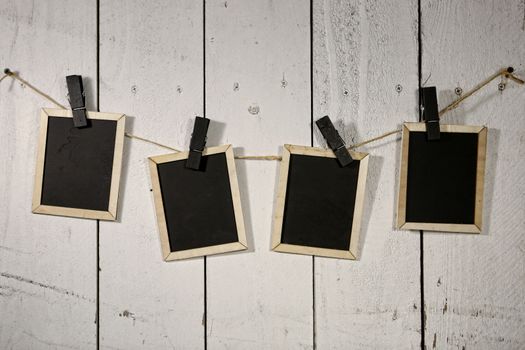 Old Film Looking Chalkboards Hanging on a Rope Held By Clothespins