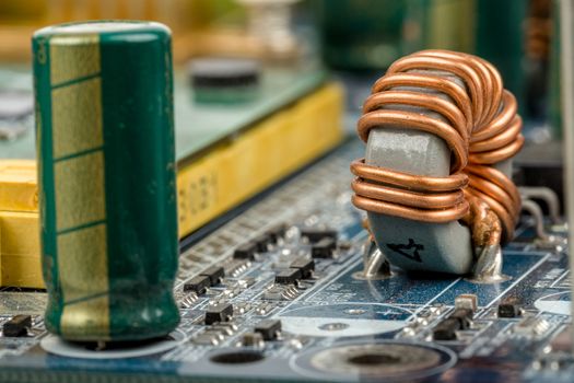 computer motherboard, detail of capacitor with shallow focus
