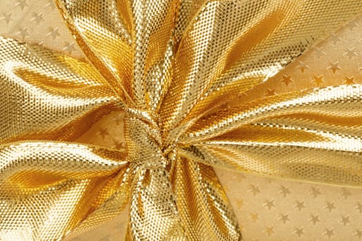 close up detail of golden ribbon on luxury gift