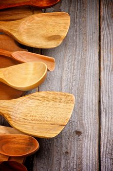 Border of Wooden Spoons and Cutting Boards isolated on Rustic Wooden background