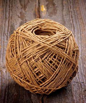Ball of String Linen Twine isolated on Rustic Wooden background