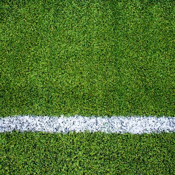 White stripe on the green soccer field from top view