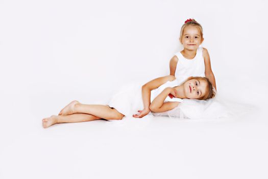 Young girls in the studio. White dresses