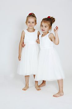 Young girls in the studio. White dresses