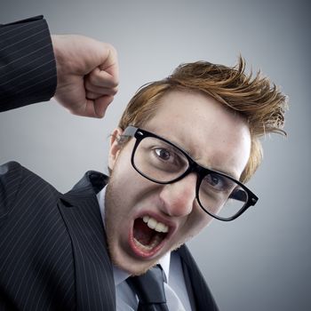 Portrait of mad Nerd businessman shouting at camera