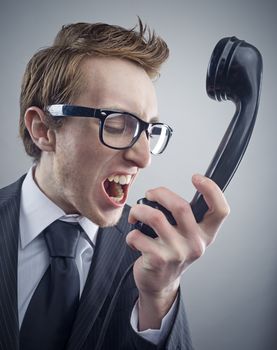 Angry nerd businessman retro telephone call shouting