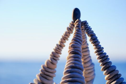 Pyramidal group of small pebbles in the balance on the seashore