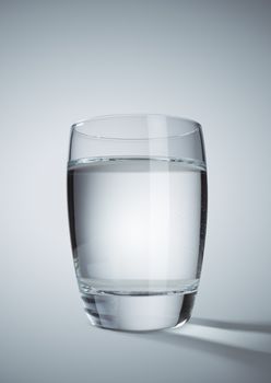 Glass of clear water on grey background