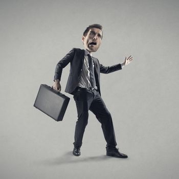 Shocked young businessman with suitcase.