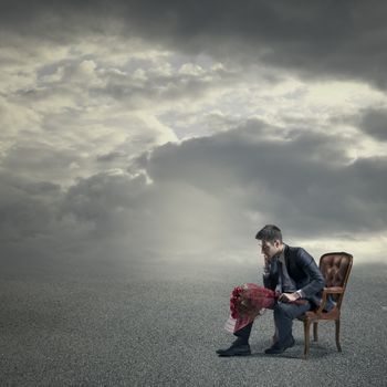 Elegant man waiting for a date with red roses.