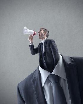 Businessman shouting through megaphone in place of head.