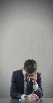 Depressed and tired office worker at desk. Copy space