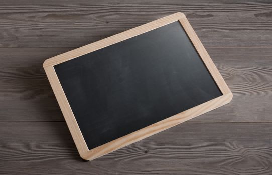 Small blackboard on table with blank copyspace.