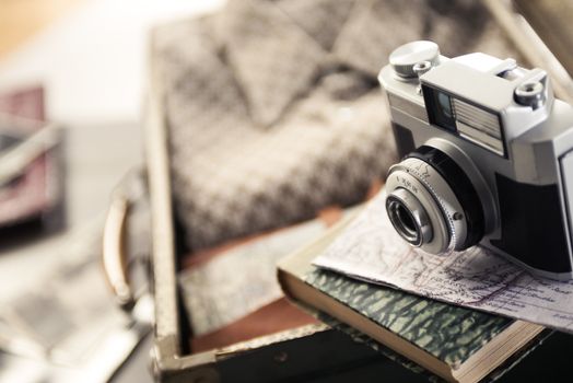 Vintage travel equipment with old camera and suitcase.