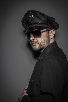 Criminal, Good looking policeman, sexy police with sunglasses over dark background