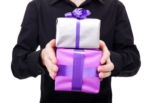 Male hand holds silver gift over a white background. Birthday or Valentine day concept.