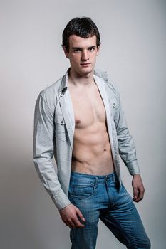 Portrait of a handsome muscular young man in shirt. Shot in a studio.