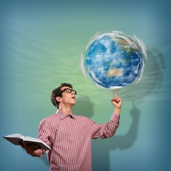 young man with a book thinks. keeps the finger symbol of the planet Earth. NASA images used