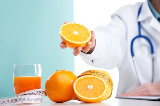 Female Nurse or Doctor holding an orange