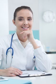 Portrait of a beautiful young female doctor or pharmacist in office