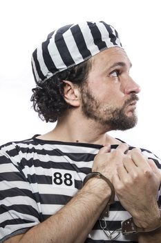 Desperate, portrait of a man prisoner in prison garb, over white background