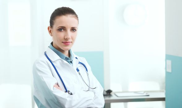 Portrait of a female doctor standing with arms folded 