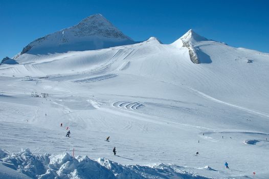 Ski slopes and skiers on Hintertux glacier in Alps nearby Zillertal valley in Austria