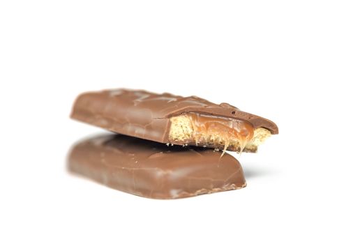 two chocolate and caramel bars on white