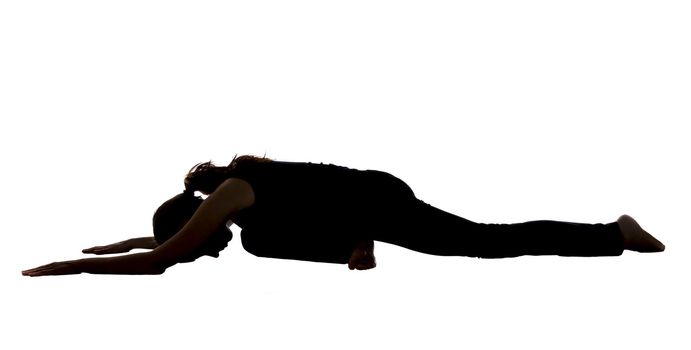 Young woman is doing a variation of Pigeon Pose in Yoga.