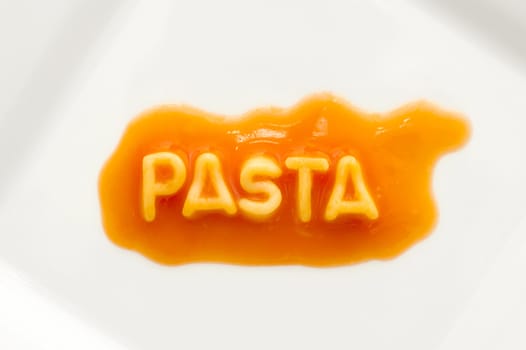 pasta spelt with spaghetti letters on a white square plate