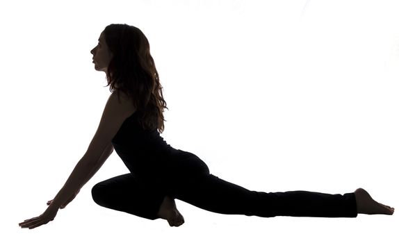 Young woman is doing Pigeon pose in Yoga.
