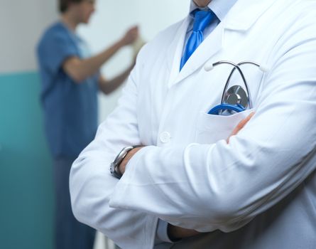 Close up of medical uniform with blue stethoscope.