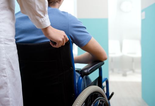 Female nurse pushing her patient on a wheelchair