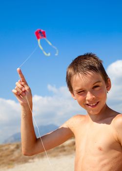 Boy flying kite on a beach