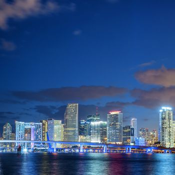 Miami Florida, sunset with colorful illuminated business and residential buildings and bridge on Biscayne Bay 