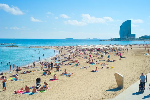 BARCELONA, SPAIN - SEPT 23, 2013: People at Barcelona city beach. 400 meters long, it is one of 10 best urban beaches of the world.