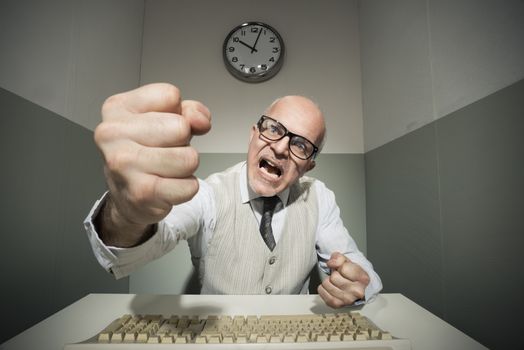 Vintage office worker angry and yelling at computer.