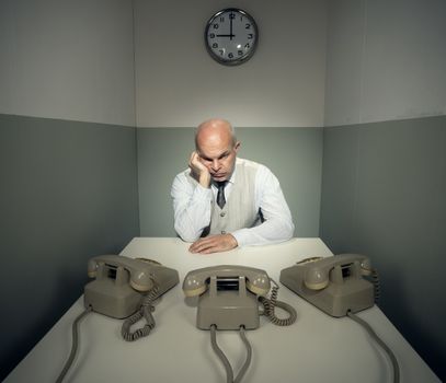 Bored vintage businessman waiting for phone calls.