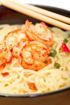 Shrimp and noodle soup bowl with chopsticks closeup