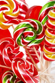 Multi-colored lollypop, closeup on a white background