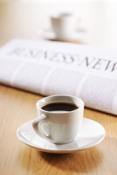 Two cup of coffee and newspaper on wooden desk